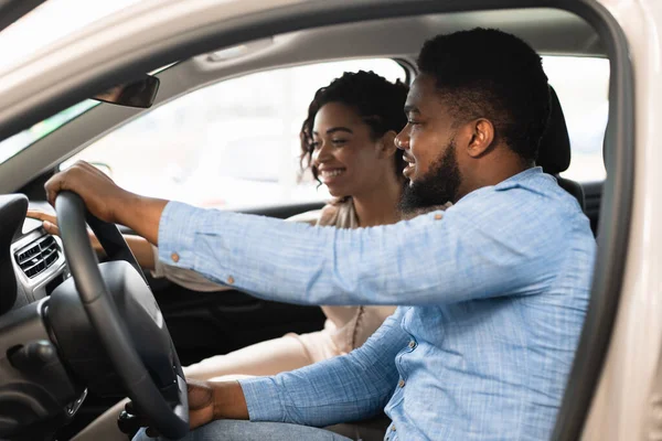 Afro cónyuges sentados en coche la elección de la familia de automóviles en el concesionario — Foto de Stock