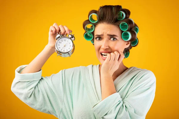 Housewife Holding Clock Being Late Standing On Yellow Background