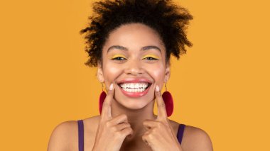 Portrait of beautiful black girl showing teeth