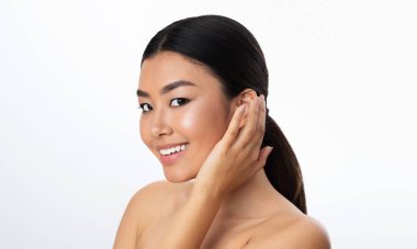 Smiling Asian Woman Posing Looking At Camera Standing In Studio