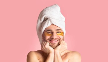 Beauty at home. Smiling man with patches under eyes