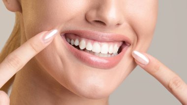 Unrecognizable Girl Pointing At Smile, Beige Background, Panorama