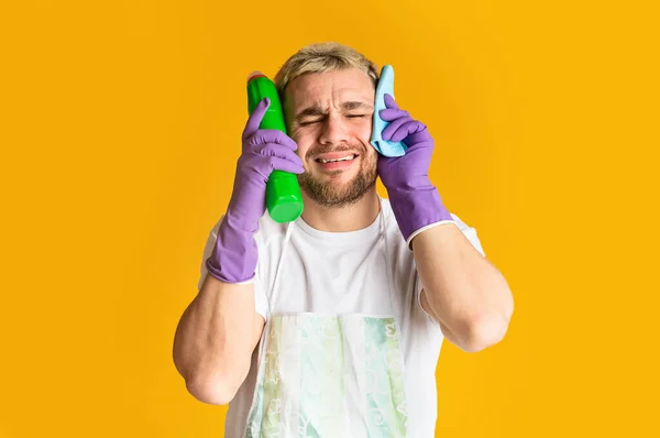 Mens cleaning concept. Tired man holds his head — Φωτογραφία Αρχείου