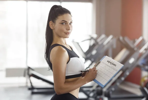 Personal trainer making workout plan for client in sports club — Stock Photo, Image