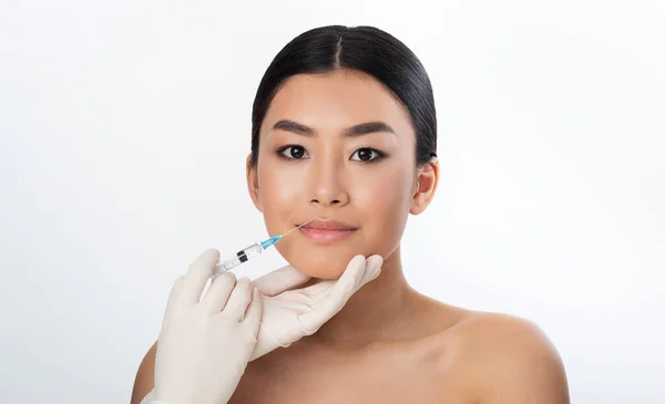 Korean Girl Receiving Injection During Lips Plumping Procedure, White Background — Zdjęcie stockowe