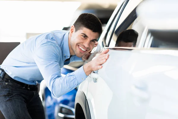 Happy Guy Touching His Auto In Dealership Showroom — Stock Fotó