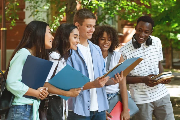 Group Of Cheerful International Students Standing Outdoors, Checking Classes Schedule Together