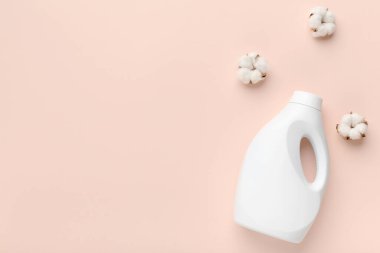 White plastic bottle of liquid laundry powder on pink