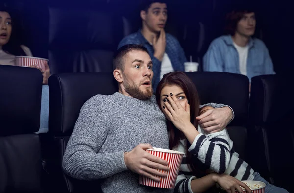Filmtermin. Entsetztes Paar sieht Gruselfilm im Kino — Stockfoto