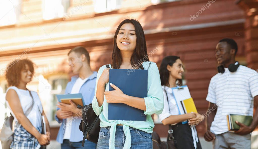 Portrait Of Happy Asian Student Girl Posing Outdoors In Campus