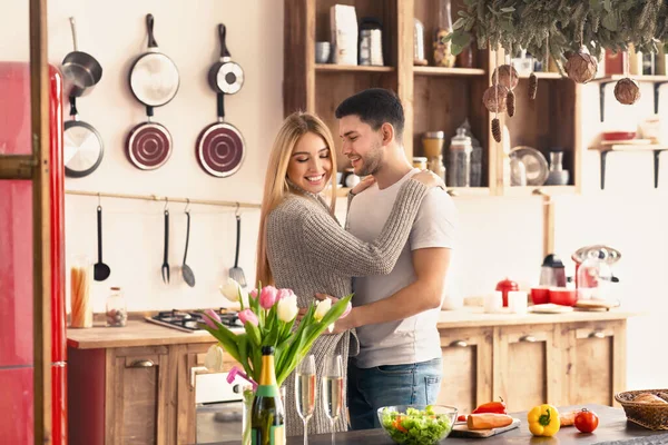 Enjoying weekend together. Happy husband and wife hugging in kitchen, empty space — Stock Photo, Image