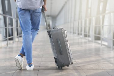 Searching For Gate. Unrecognizable Man Standing With Suitcase In Airport Terminal