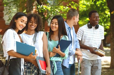Group of international students resting in campus during break in classes