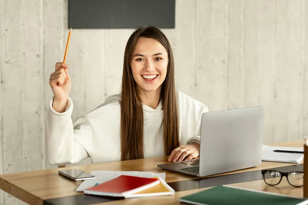 Got an idea. Girl lifts up a pencil