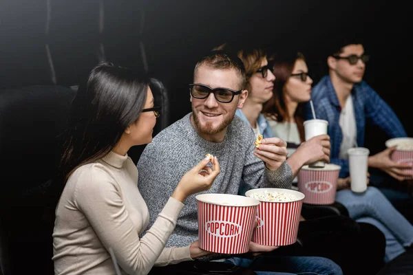 Friends in 3D glasses talking while waiting for movie premiere in cinema — Stock fotografie