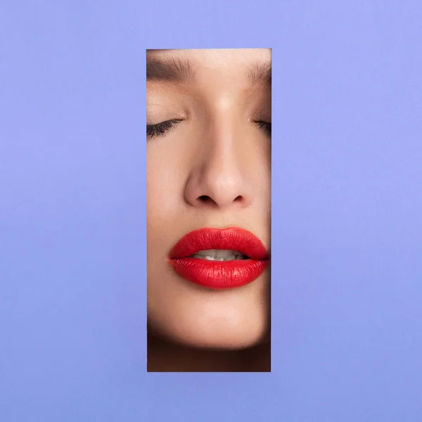Mooie vrouw met rode lippen gluuren uit gescheurd papier — Stockfoto