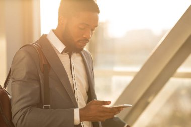 Entrepreneur Using Smartphone With Business Travel Application Walking In Airport