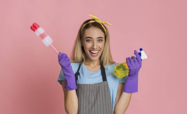 Housewife is ready to clean house with spray and brush in her hands