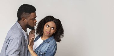 Coronavirus Precautions. Disgusted Black Woman Pushing Away Boyfriend, Refusing His Kisses