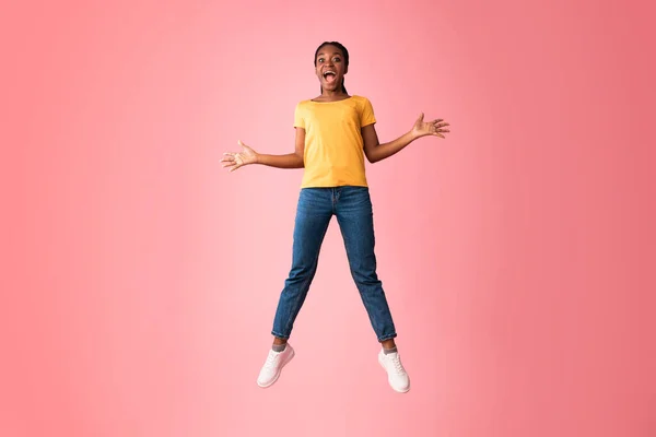 Excited Millennial Girl Jumping And Shouting Over Pink Background — 图库照片