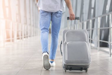 Weekend Trip. Unrecognizable Man Walking With Luggage In Aiport, Rear View