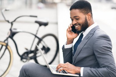 Handsome manager having business talk in park