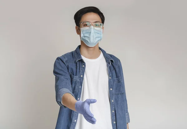 Chinese Guy In Medical Mask And Gloves Giving Hand For Handshake