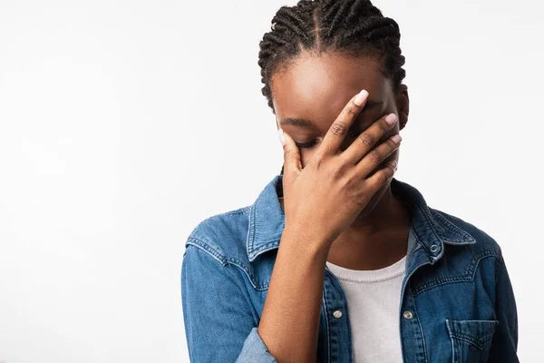 African American Woman Covering Face With Hand Over White Background — Stock Photo, Image