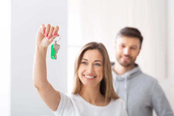 Happy young woman holding keys from new apartment — Stock Photo, Image