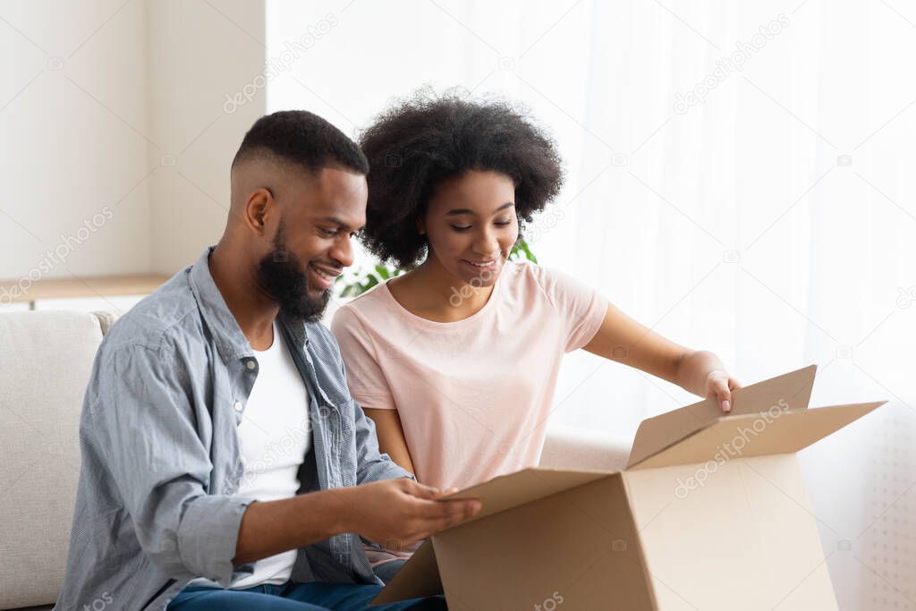 Man and woman opened package and glad to purchase