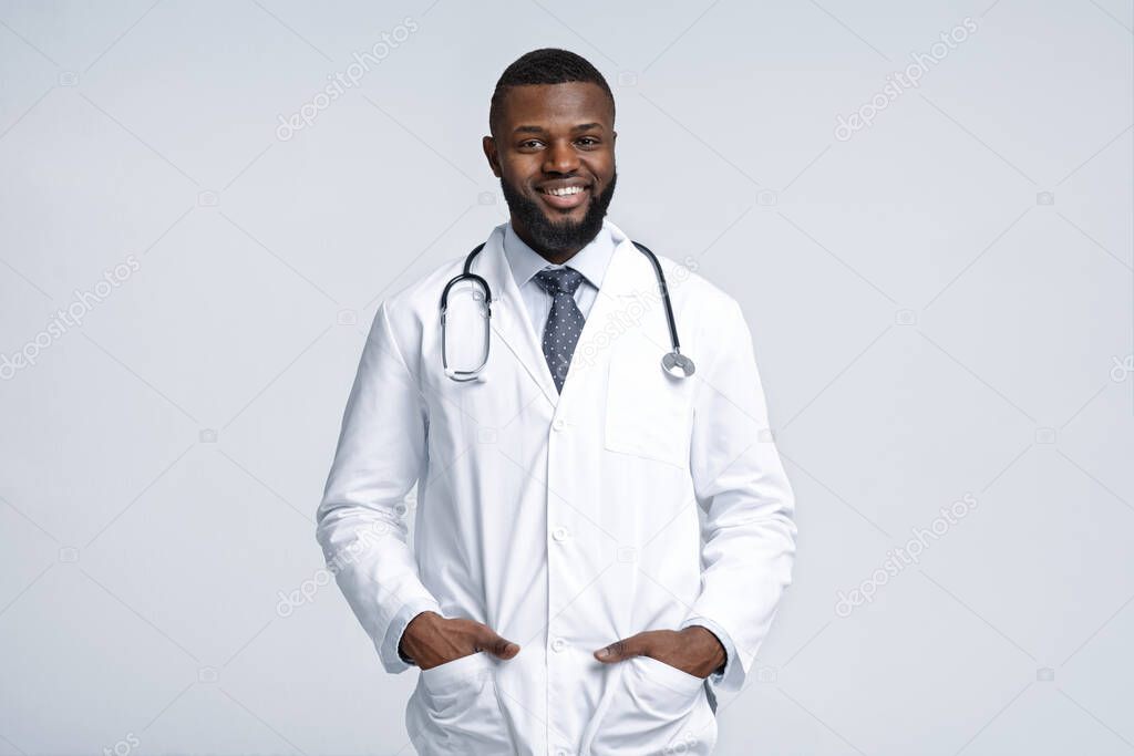 Friendly african male therapist posing over white background