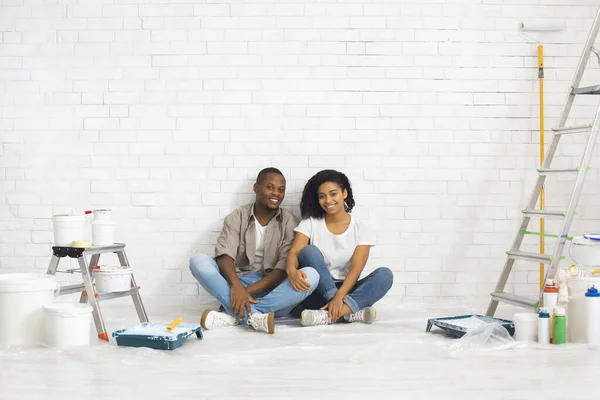 Husband and wife with tools for repair on white brick wall background — Stock Photo, Image