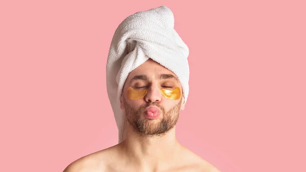 Man making lips for kiss with patches for eyes — Stock Photo, Image