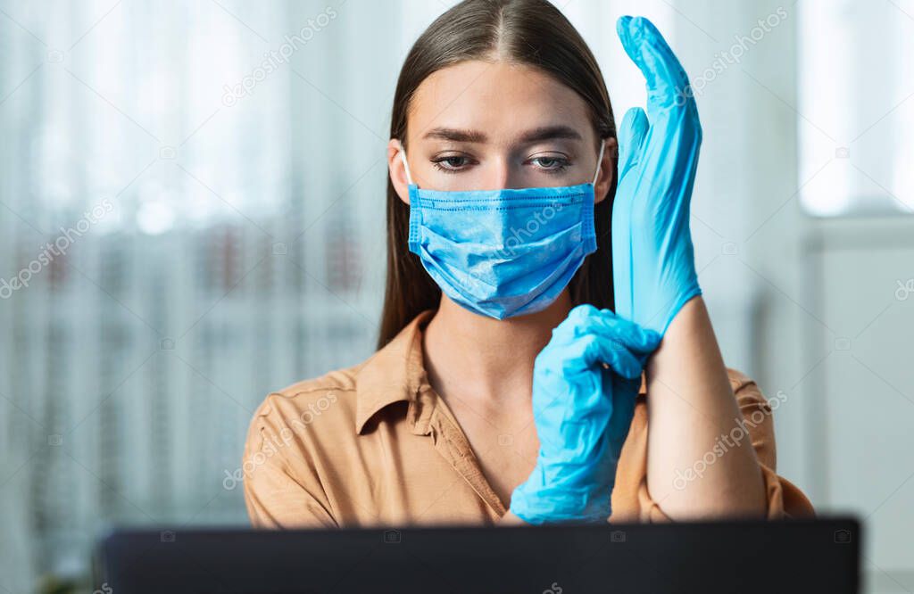 Woman in quarantine wearing gloves and working