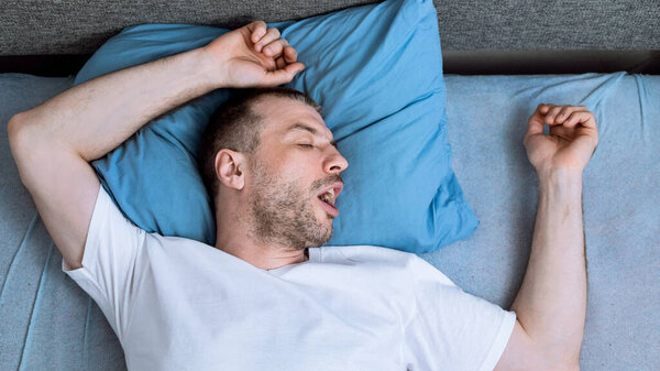 Man Sleeping In Bed At Home During Pandemic Self-Isolation, Panorama