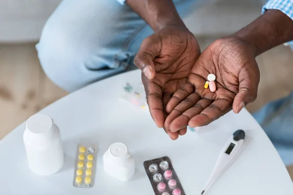 Terapia con Coronavirus. Primer plano del hombre afroamericano con drogas en el interior, vista superior. Espacio vacío — Foto de Stock