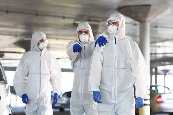 Frightened Man in virus protective suit showing with finger on something — Stock Photo, Image