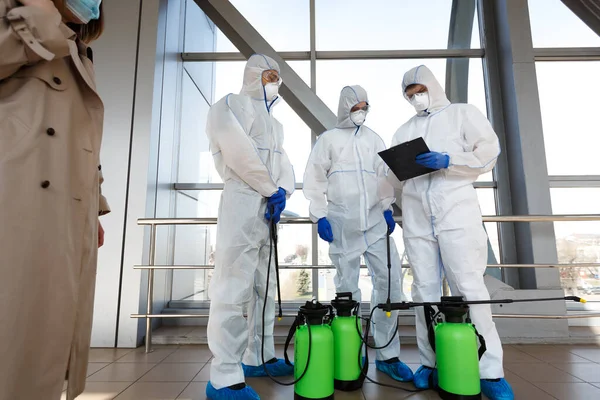 Pessoas em trajes de proteção de vírus plano de leitura da desinfecção da cidade — Fotografia de Stock