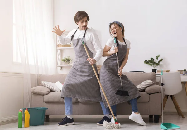 Couple Having Fun While Tidying Home, Dancing With Mop And Broom — Stock Photo, Image