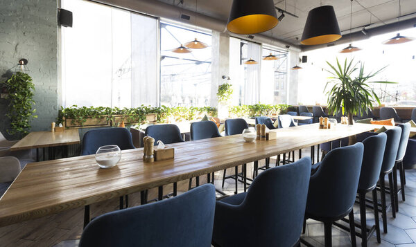 Cozy modern interior of restaurant with empty tables