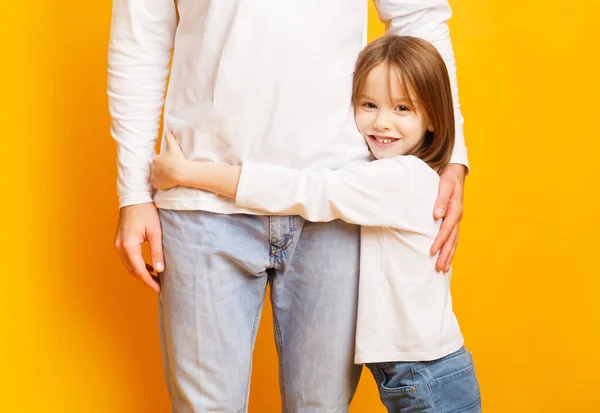 Happy preschool girl hugging her daddy with love — Stock Photo, Image