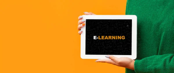 COVID-19 격리 기간의 온라인 교육. 화면에 단어 E-learn 와 함께 태블릿을 들고 있는 여성, 복사 공간, — 스톡 사진