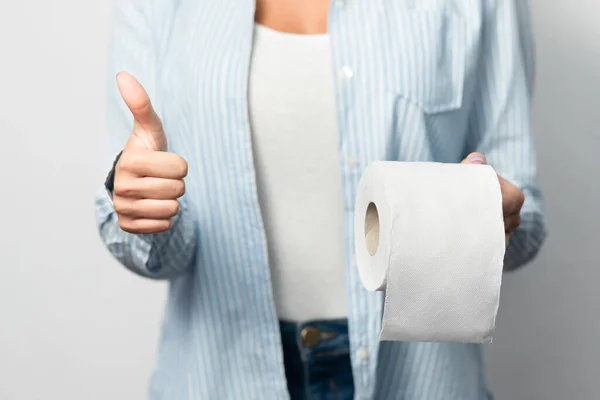 Woman Holding Toilet Paper Gesturing Thumbs-Up Over White Background, Cropped — Stock Photo, Image
