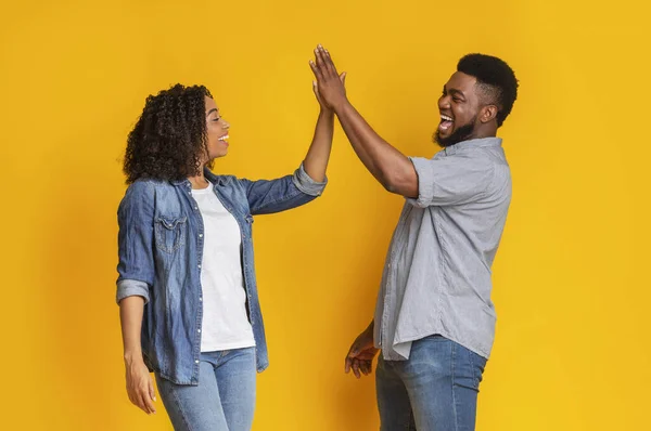 Gemeinsamer Erfolg. Glückliches afrikanisch-amerikanisches Paar gibt High-Five und grüßt sich — Stockfoto