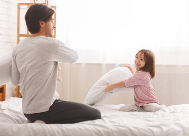 Baba ve kızı sabahları yastık savaşı yapıyorlar.