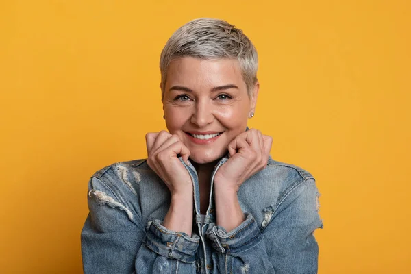 Portret van vrolijke volwassen vrouw glimlachen en op zoek naar camera — Stockfoto