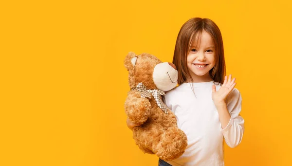 Cute little girl hugging teddy bear Stock Photo by ©Milkos 205350192