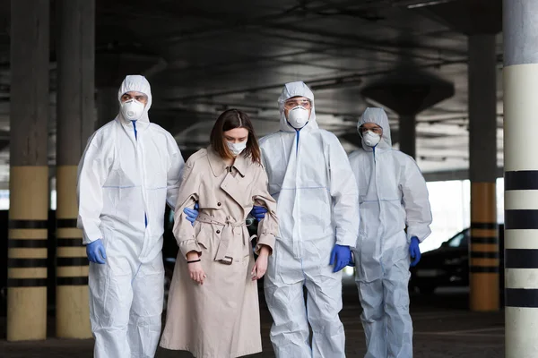 Medical workers in hazmat suits carry infected woman