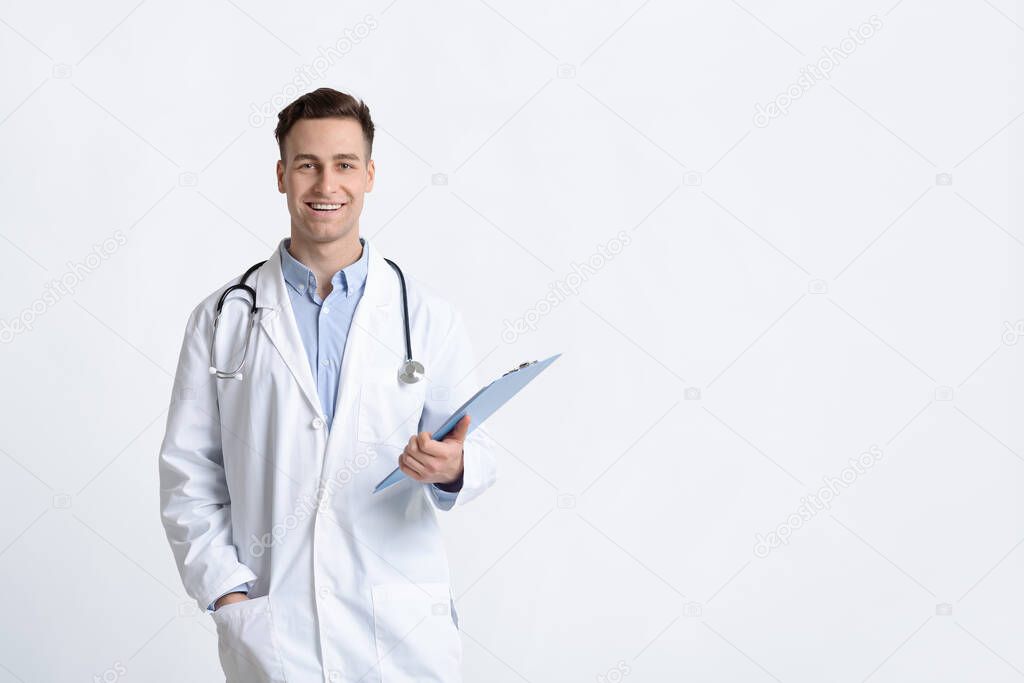 Smiling doctor in white coat with tablet