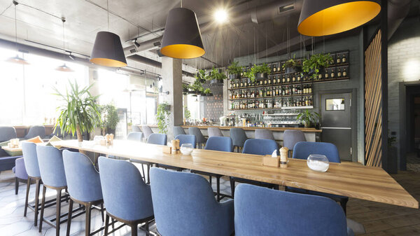 View on bar counter from tables in modern cafe